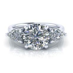 Three stone engagement ring with pear shaped accent gems