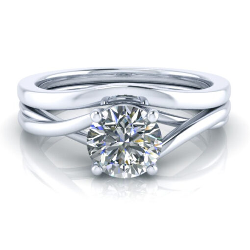 White gold plain contour wedding ring laying with matching engagement solitaire ring.