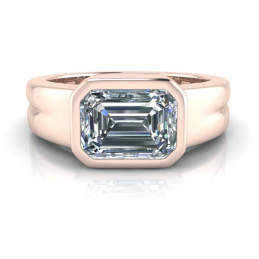 Bezel set emerald cut engagement ring with grooved ring shank in 14k rose gold.