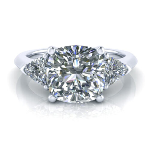 Picture of cushion cut and trilliant cut three stone engagement ring in white gold and platinum.