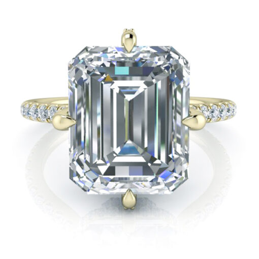 Emerald cut hidden halo ring in yellow gold. Compass point prong setting.