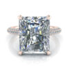 Rose gold 5 carat radiant cut under halo engagement ring with pave accent diamonds.