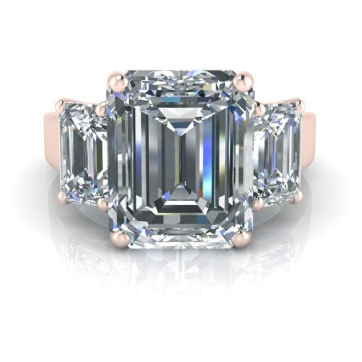 Rose gold three stone emerald cut engagement ring.